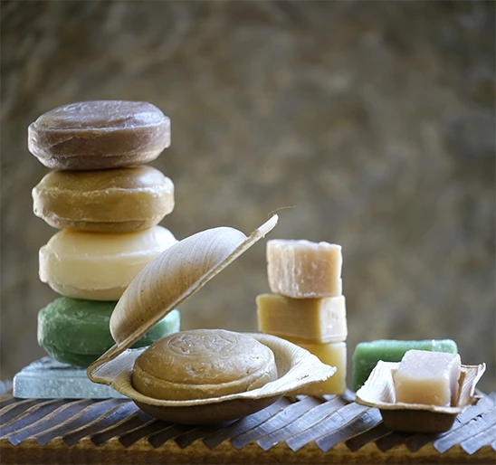 Ayurvedic soap in the foreground in its plant-based shell, accompanied by other Karawan soaps