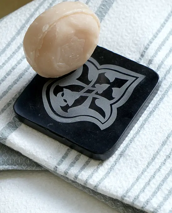 Black soap dish on an organic cotton fouta